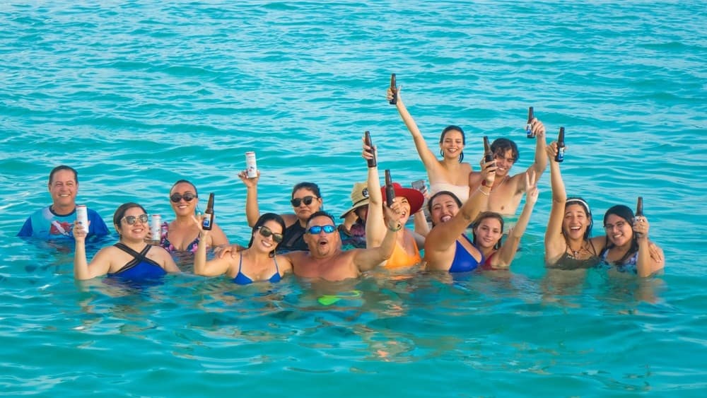 Snorkeling group celebrating in clear turquoise Cozumel sea