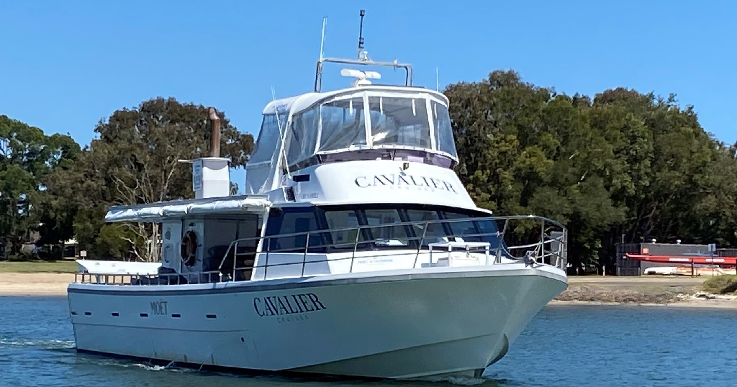 Motor yacht cruising coastal waters near Sunshine Coast harbor