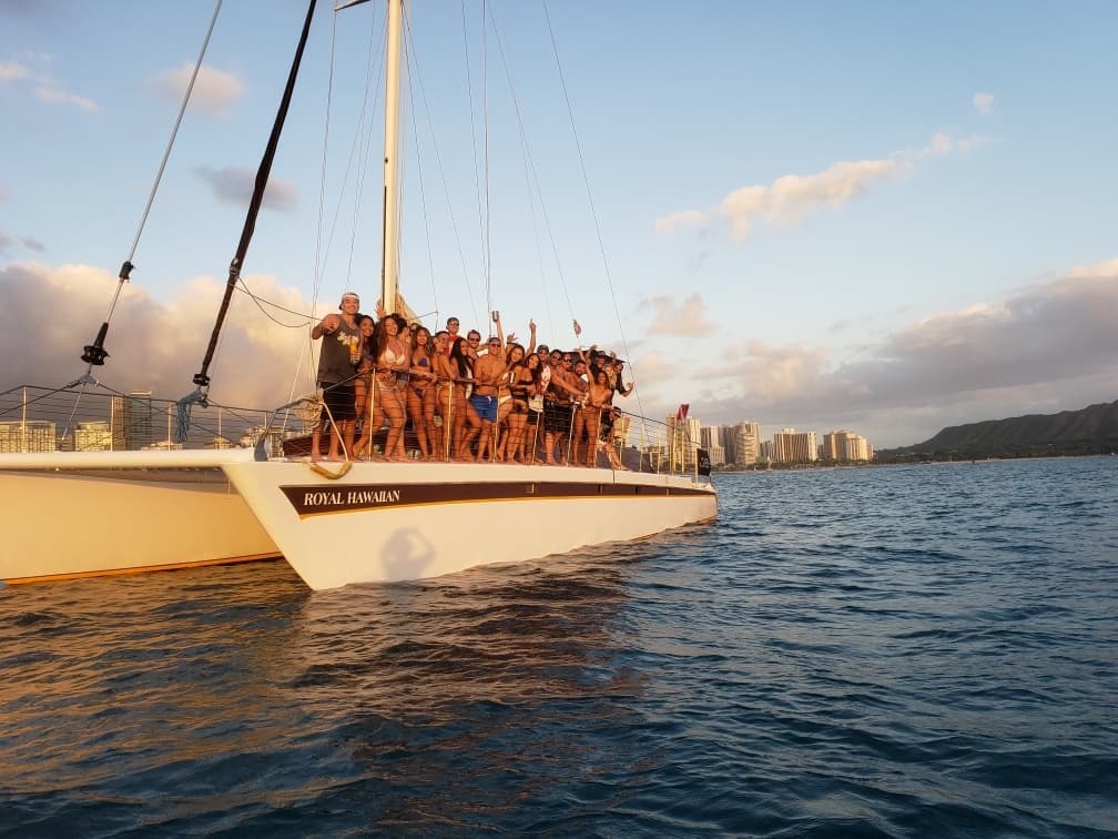Sunset catamaran cruise with passengers off Waikiki coast