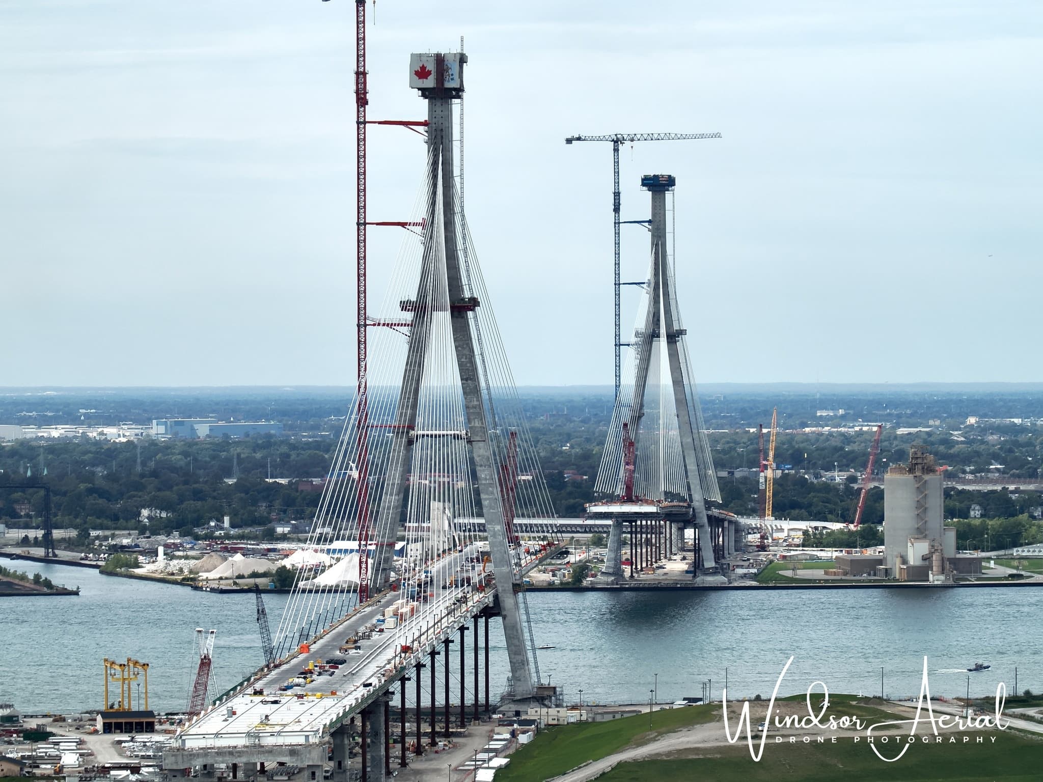 Cable-stayed international bridge spanning river with city skyline view