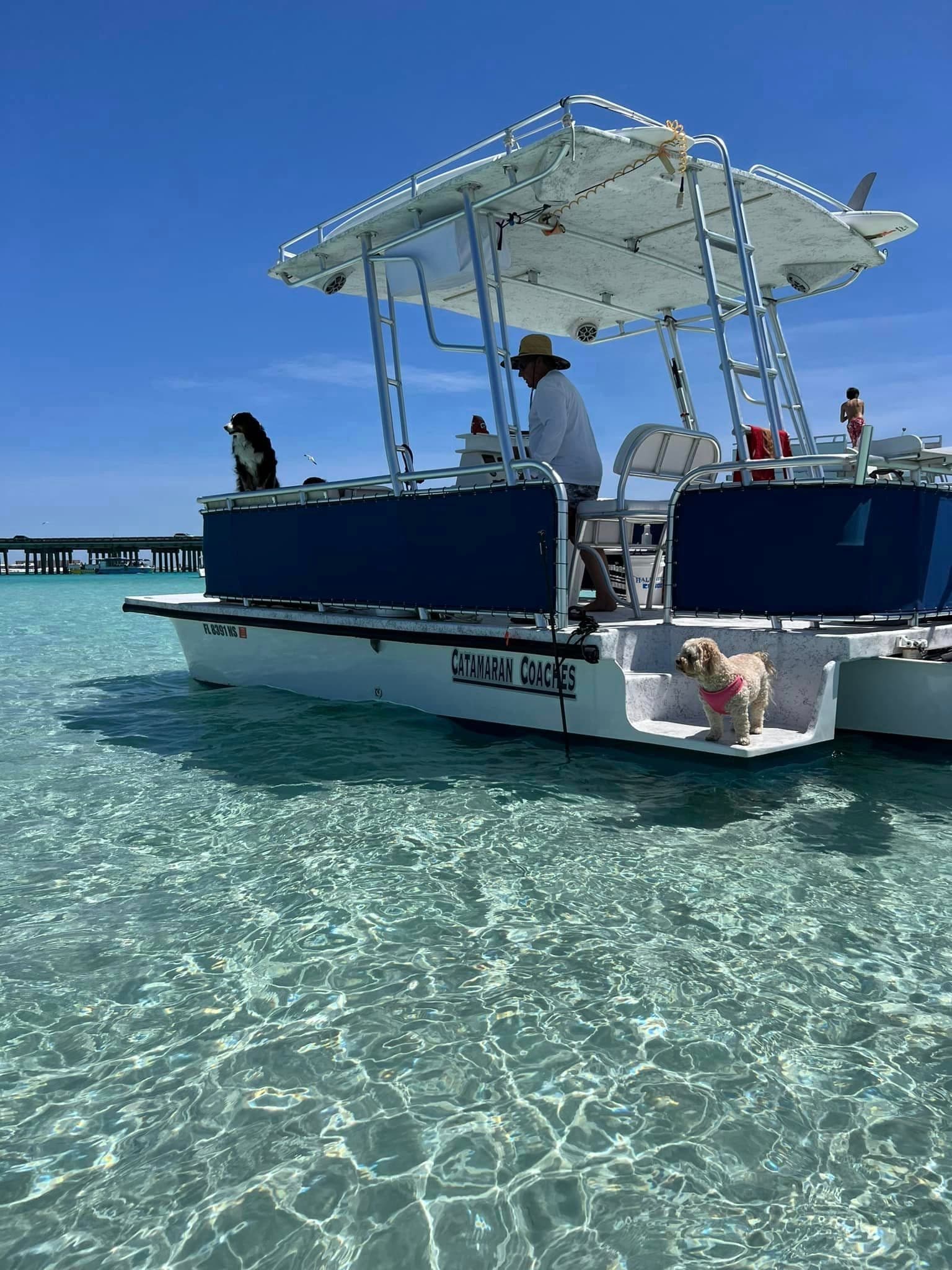 Charter boat anchored in crystal clear shallow water, island stop