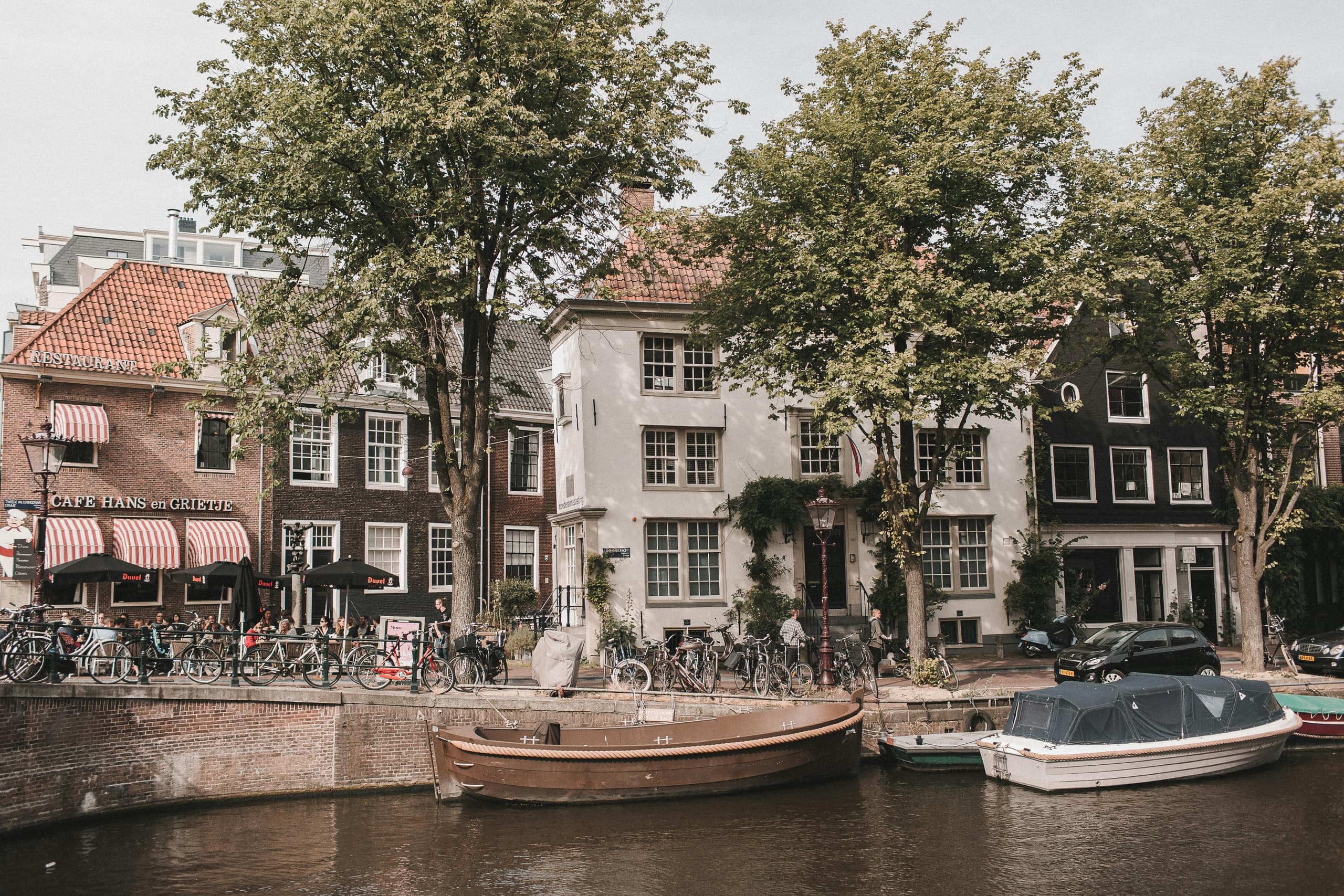 Boats moored on Amsterdam canalfront for scenic boat tours