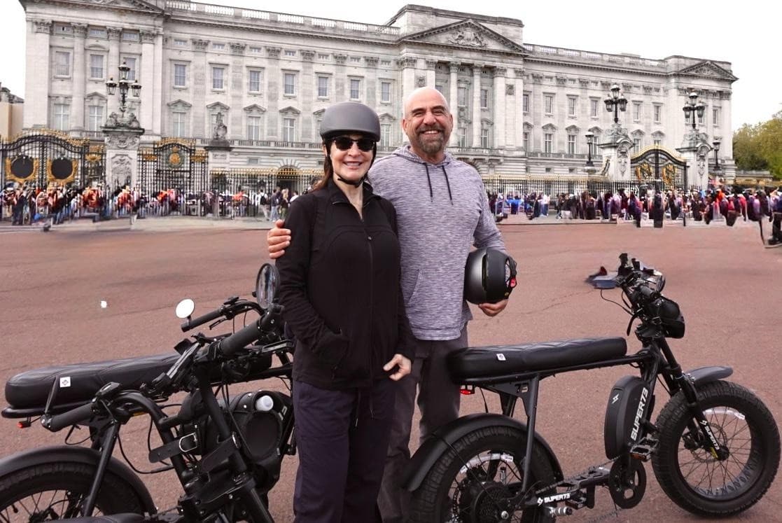 Group e-bike tour gathering at historic urban square monument