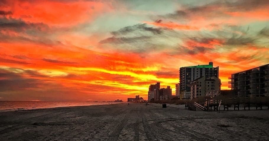 Vibrant beach sunset over oceanfront boardwalk and hotels