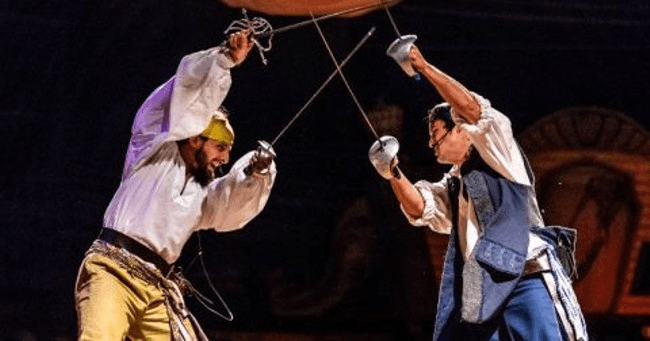 Actors engaged in choreographed sword duel at Orlando pirate show