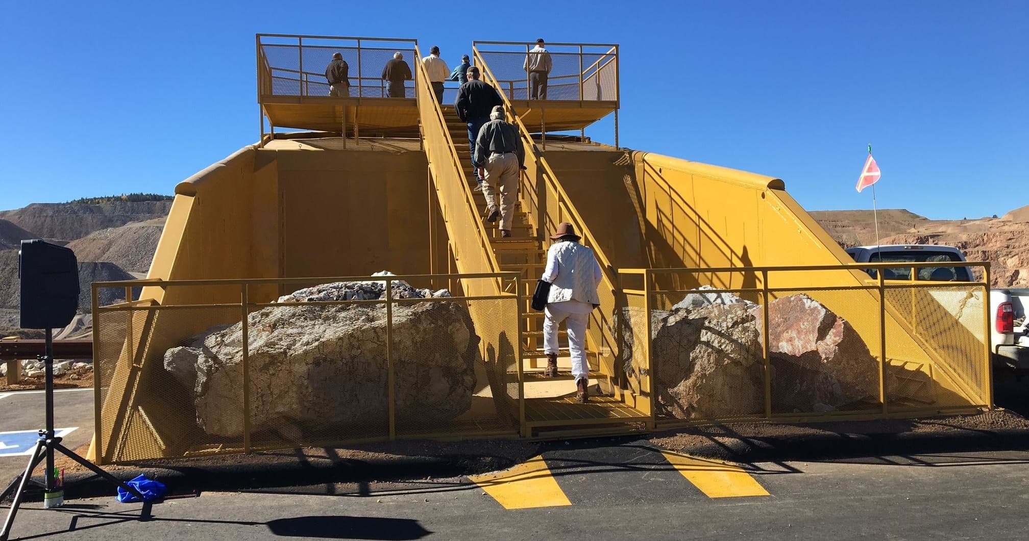 Visitors climbing yellow mine safety exhibit in Victor, Colorado