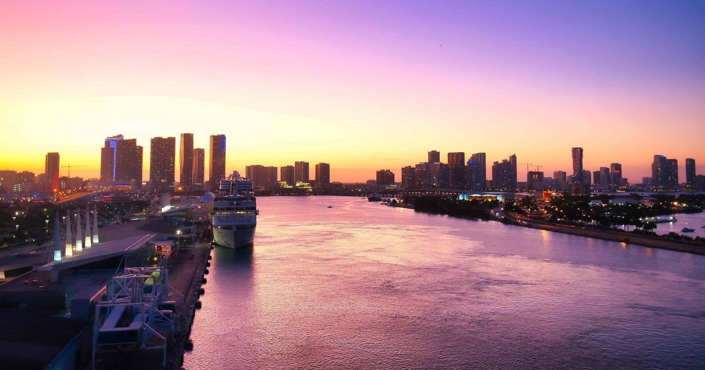 Sunset cruise view of Miami River and city skyline at golden hour
