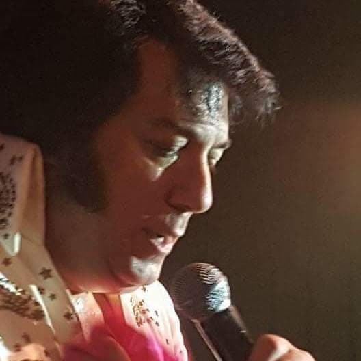 Close-up of singer performing on indoor stage with microphone