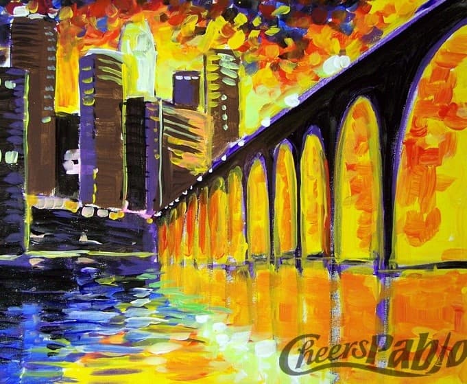 City skyline and arched bridge over river at golden sunset