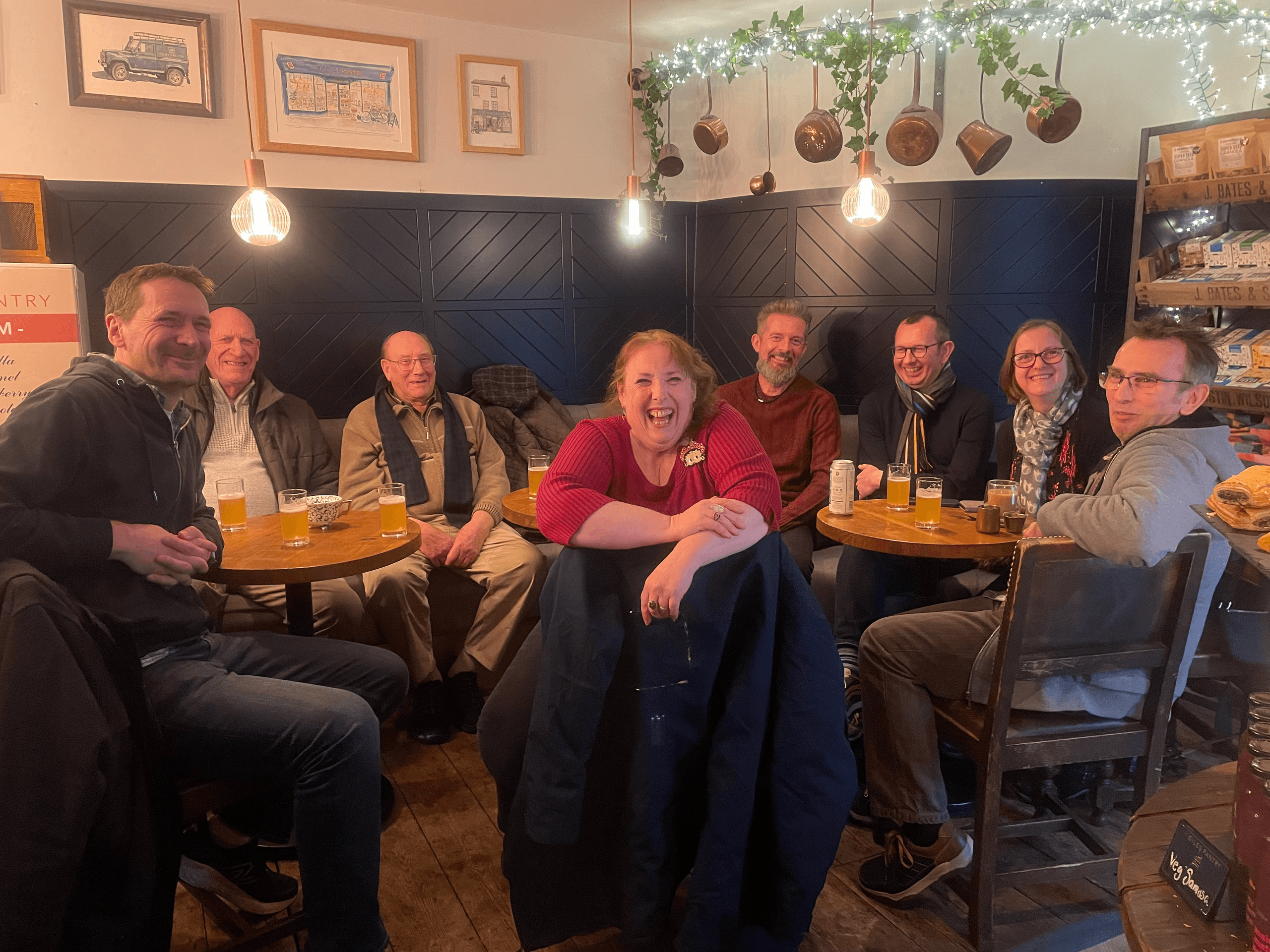Group of friends socializing over drinks inside a cozy pub