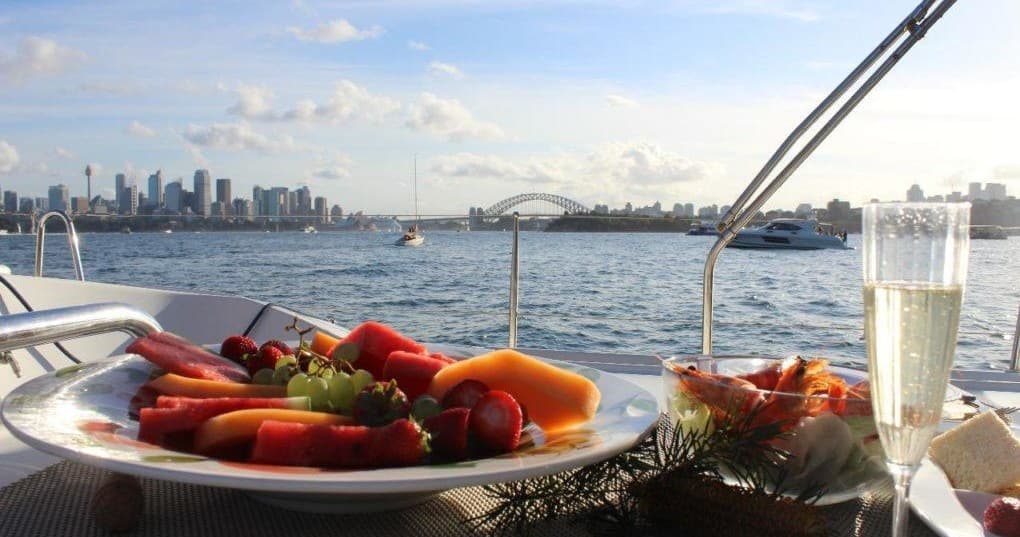 Alfresco seafood platter with Sydney Harbour skyline on cruise
