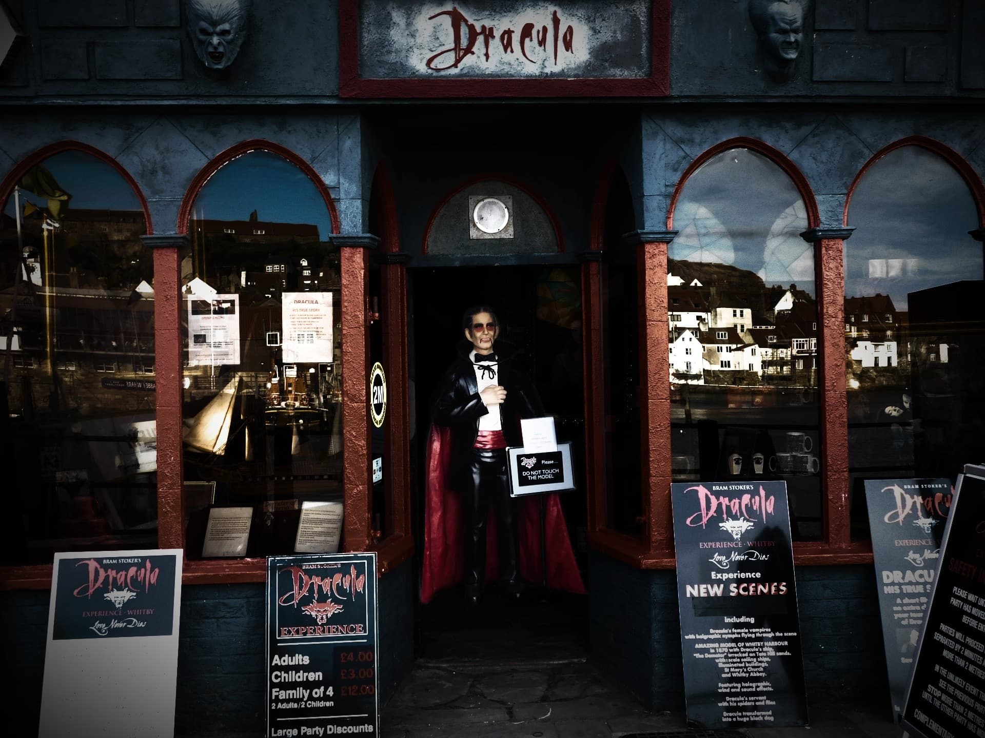 Dracula attraction storefront on waterfront with vampire mannequin