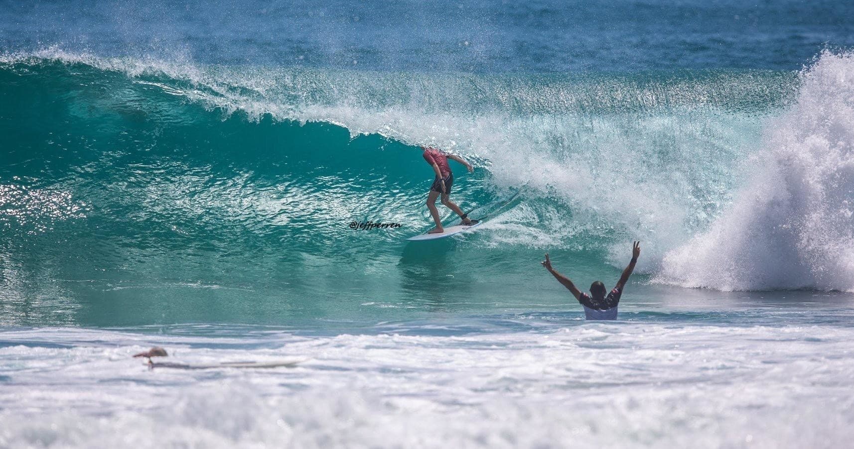Surfer in a barreling wave during an intense ride at sandy beach
