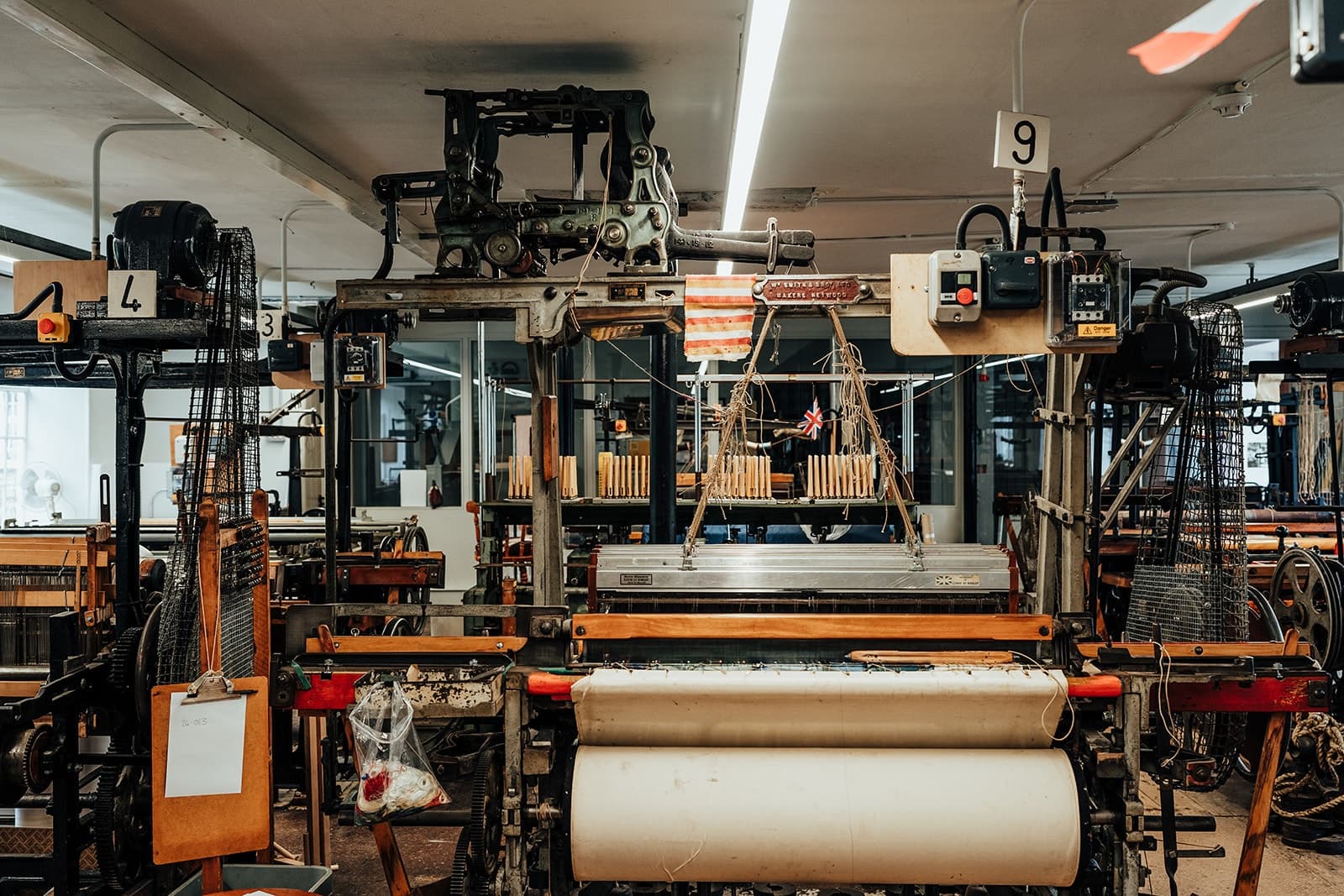 Factory textile looms interior showing historic weaving machines