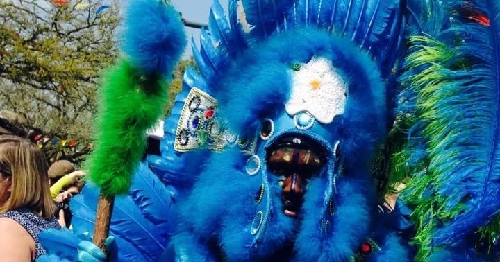 Colorful Mardi Gras second line marcher in vibrant costume