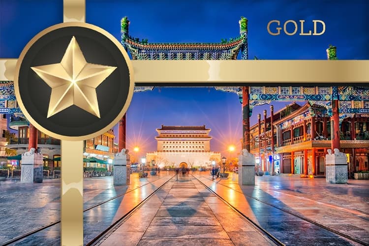 Visitors strolling past illuminated historic Chinese gate plaza at night