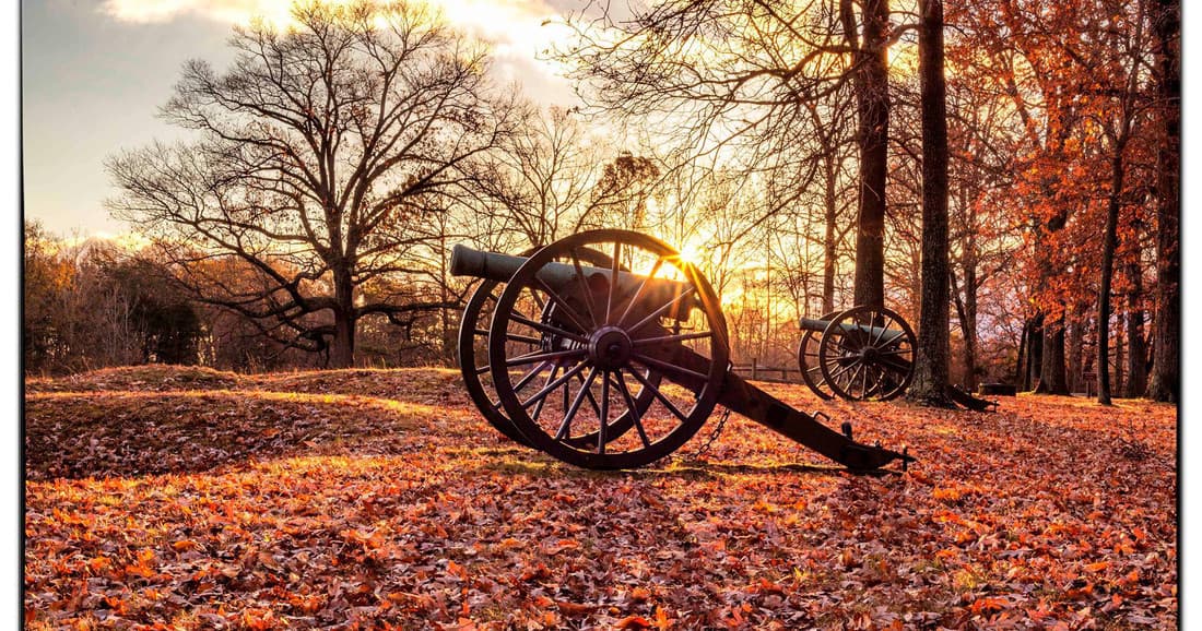 Historic field cannon at sunset in wooded battlefield park