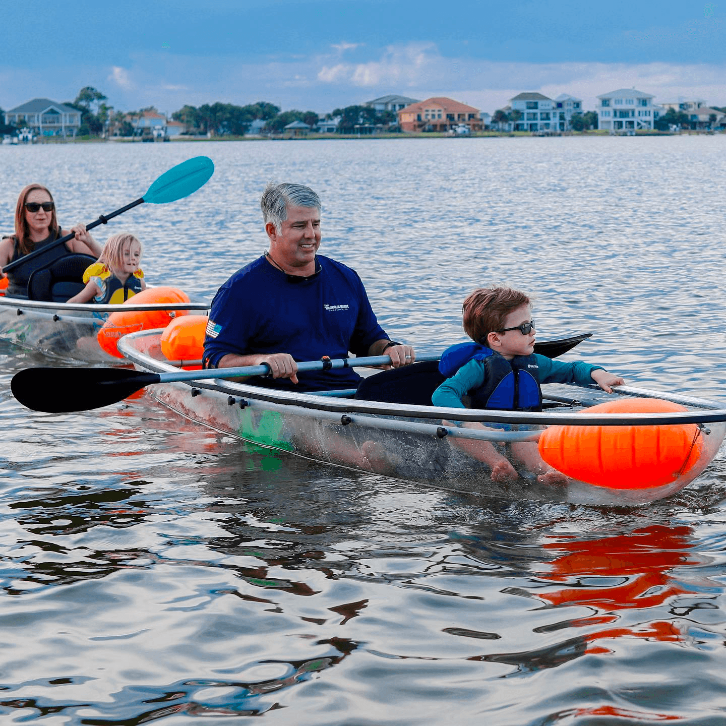 Family kayaking in clear tandem kayak on calm Key West waters