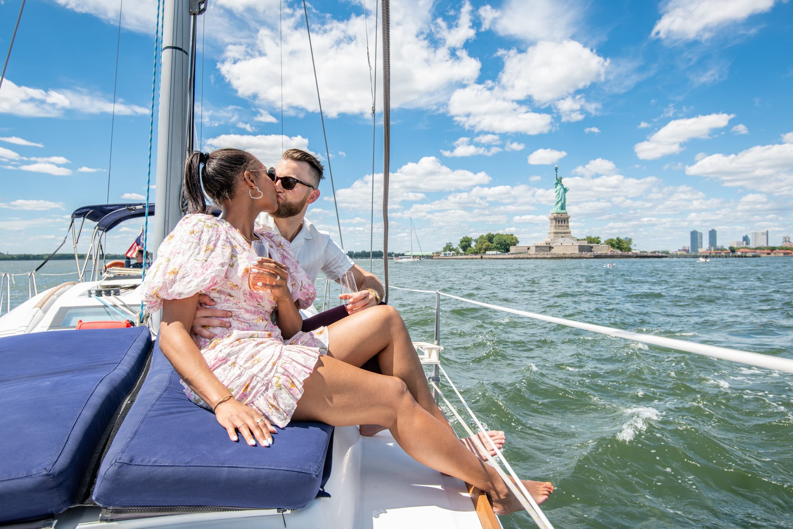 Couple sailing near Statue of Liberty on sunny NYC cruise