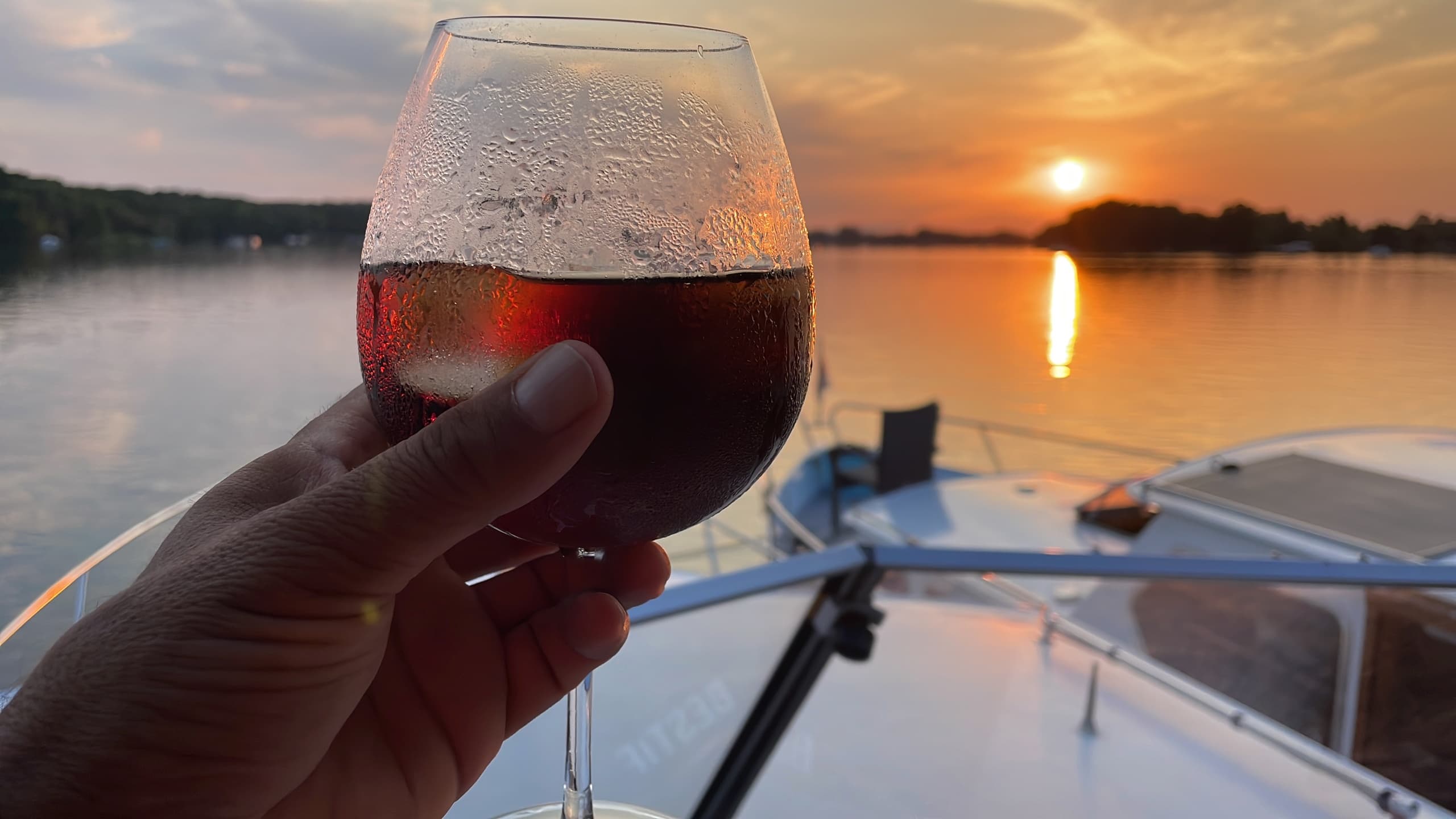 Sunset cruise on river with wine glass aboard boat in Potsdam