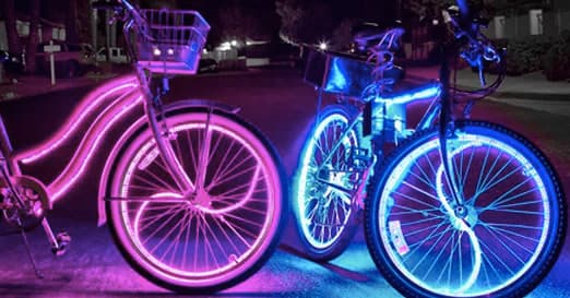 Urban cruiser bikes with neon wheel lights at night street