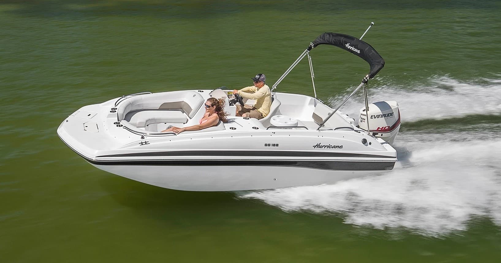 Speedboat cruising on a green lake creating wake