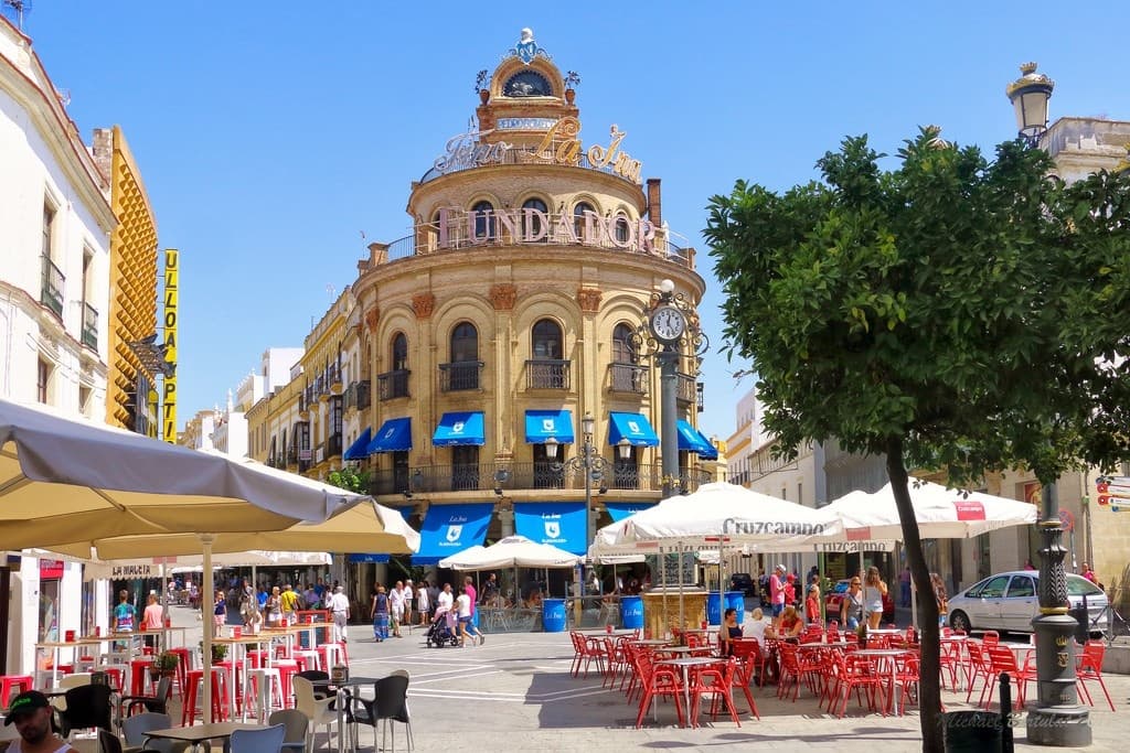 Sunny Cádiz city square with outdoor cafés and plaza views