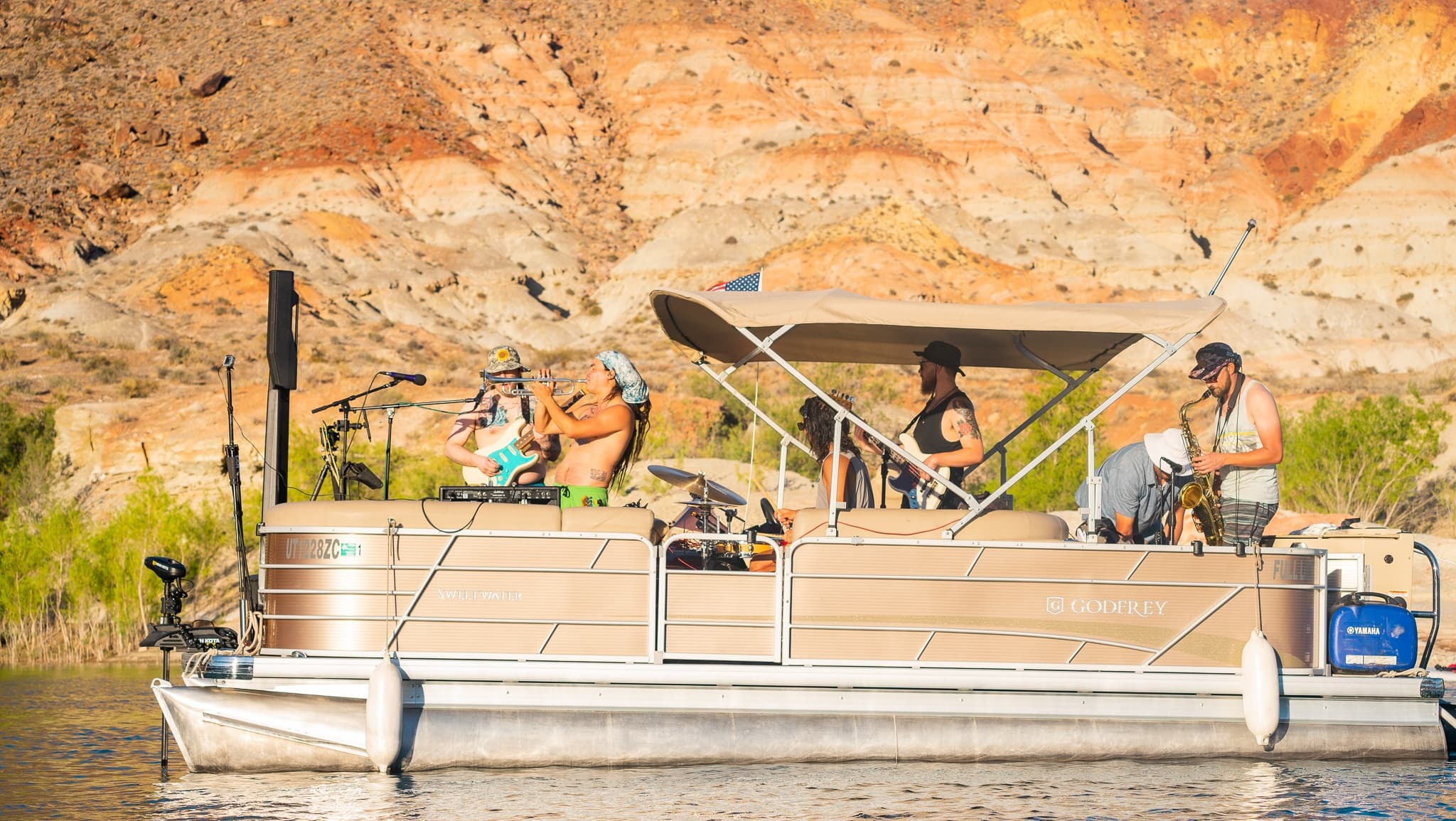 Pontoon boat cruising canyon lake with people onboard