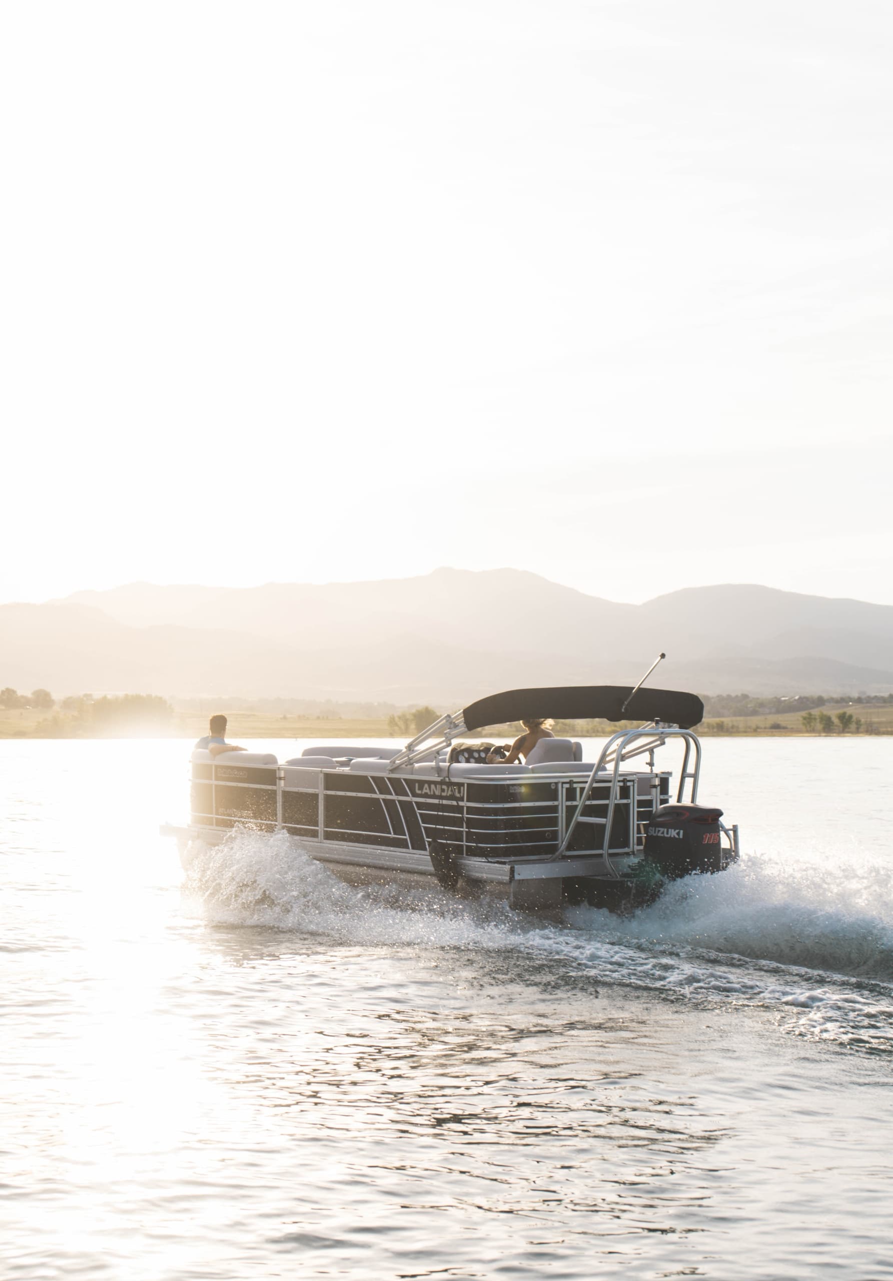 Motorboat escort with paddleboarders on scenic alpine reservoir