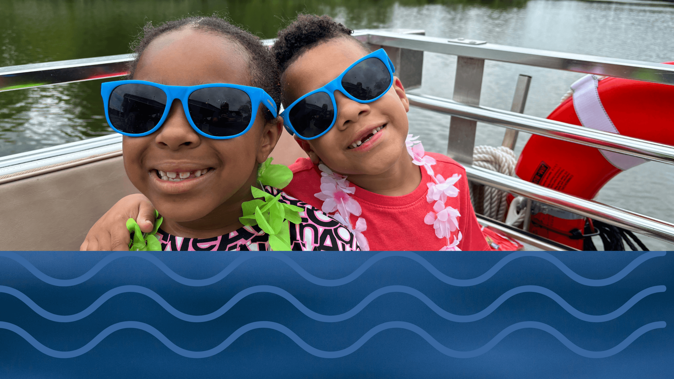 Kids wearing sunglasses enjoying family boat tour on lake