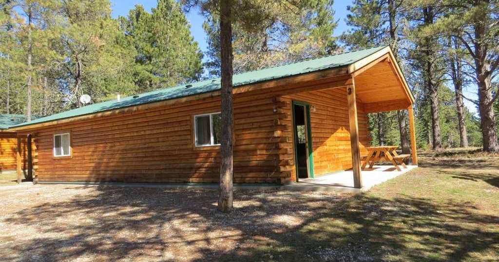 Rustic wooden lodge with balcony among pines for mountain stays