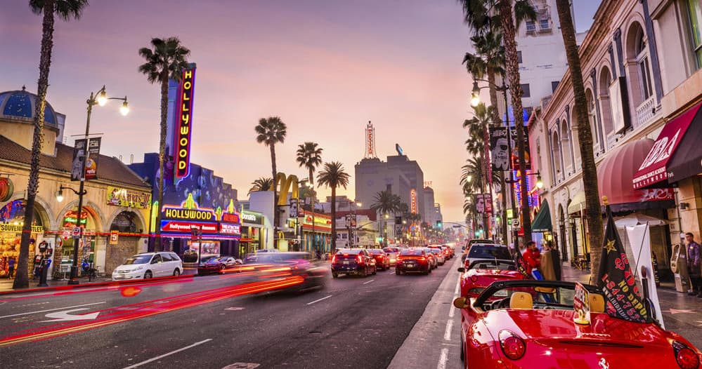 Hollywood Boulevard street scene with palm trees and neon lights