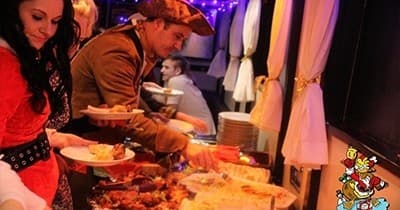 Passengers enjoying buffet on party boat cruise interior