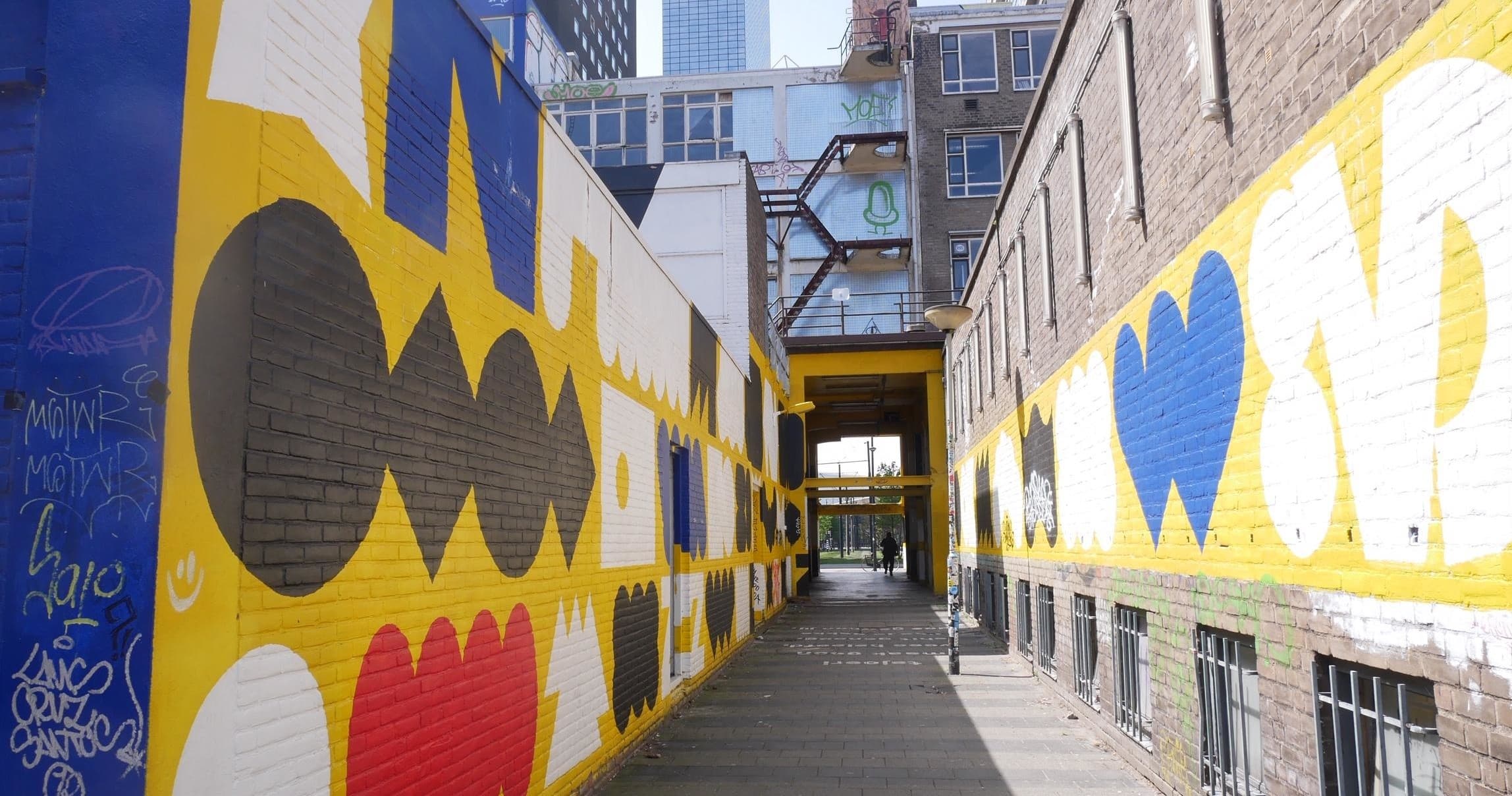 Colorful street art corridor on Rotterdam walking tour showcasing murals