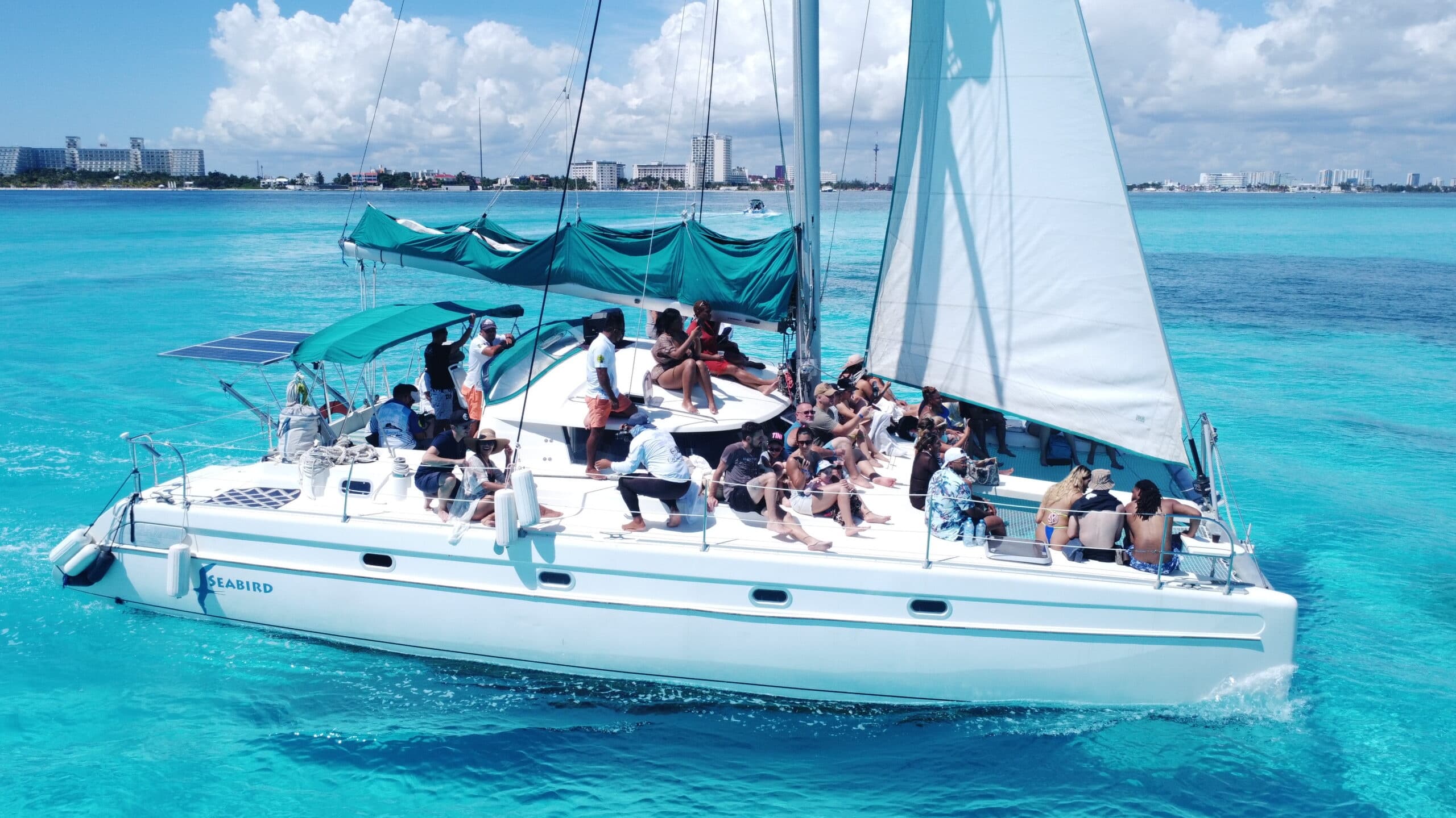 Catamaran day cruise with passengers on vibrant Caribbean waters
