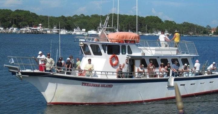 Mid-size fishing boat on calm bay with anglers aboard