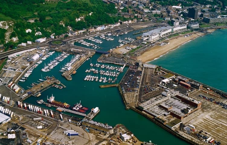 Aerial view of coastal harbor and marina with moored boats