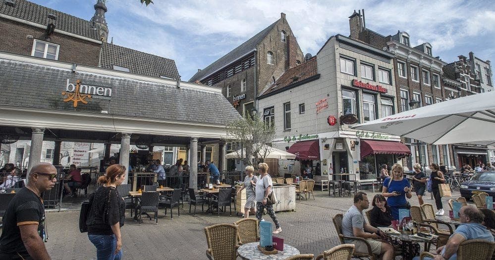 Outdoor cafe scene at lively town square in Breda center