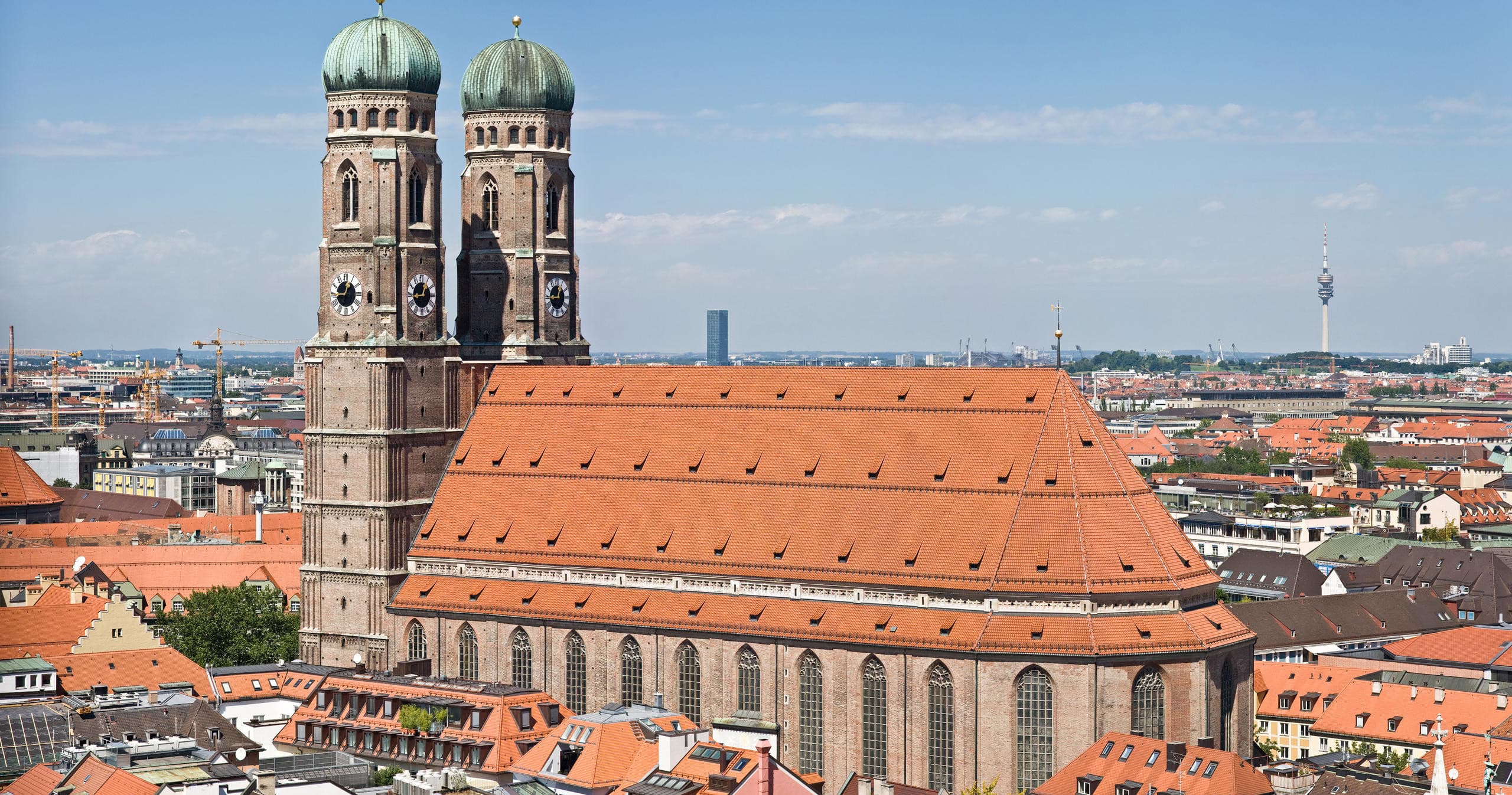 Panoramic rooftop view of Munich skyline featuring Frauenkirche