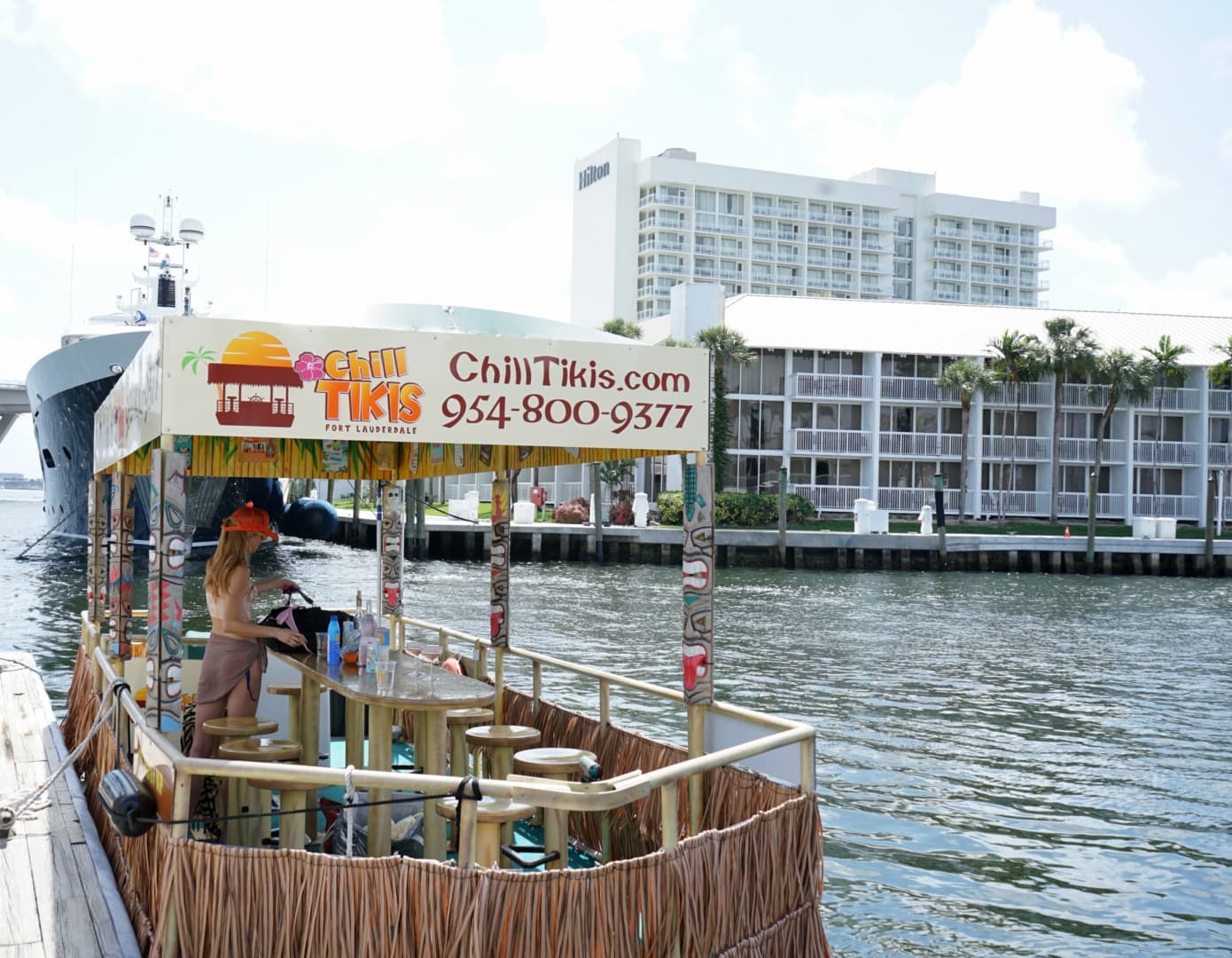 Tiki party boat docked on waterfront canal for cruising