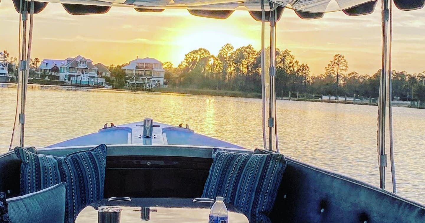 Sunset cruise aboard leisure boat on calm coastal bay