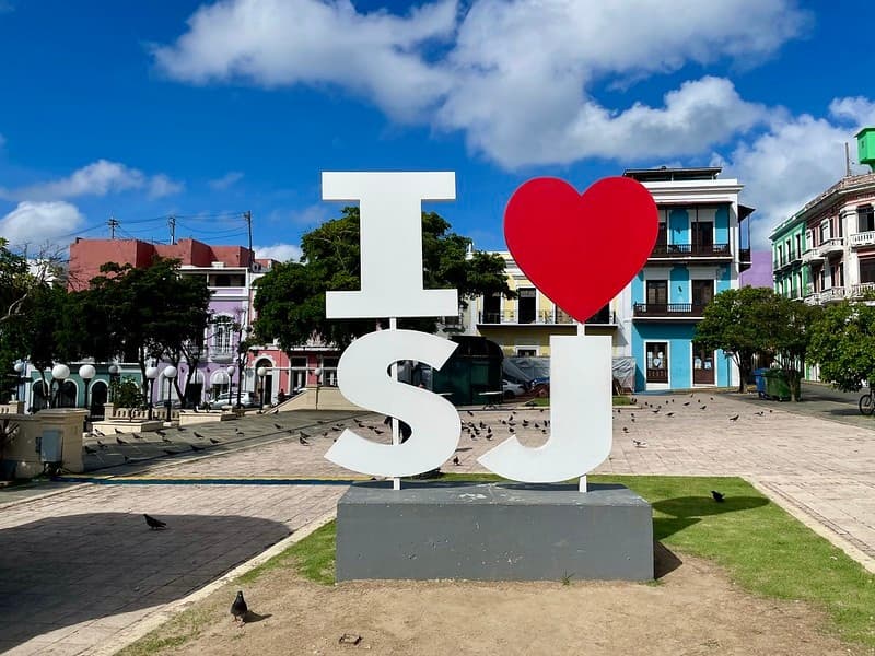 I heart SJ plaza sign in colorful historic square under blue sky