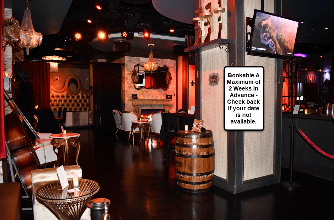 Dimly lit speakeasy bar interior with vintage seating and stage