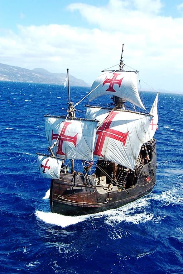 Replica Columbus-era sailing ship cruising deep blue ocean