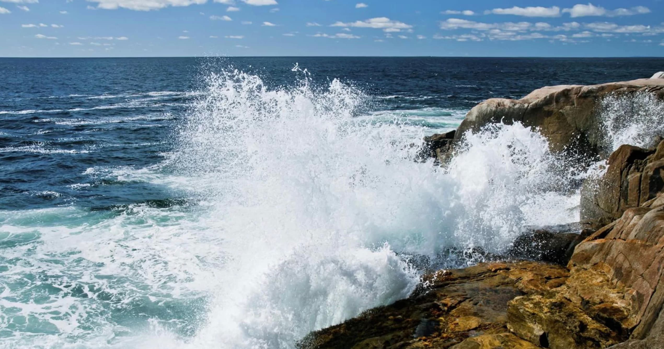 Wide coastal panorama of Peggy's Cove rocks and sea sky