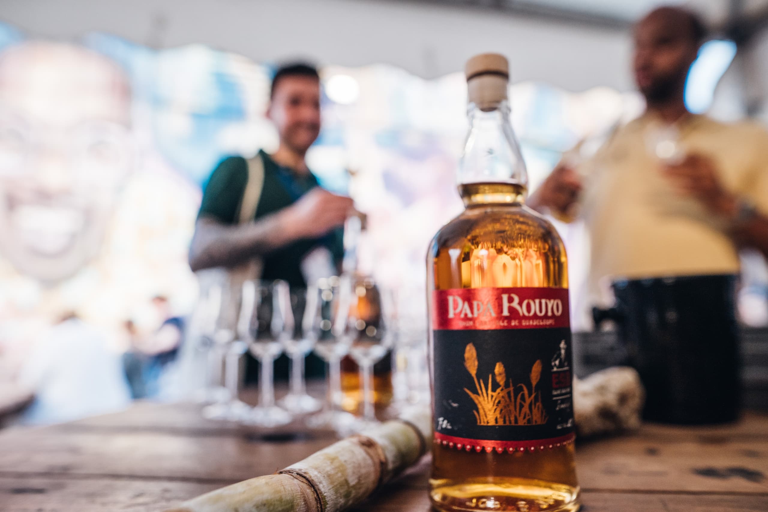 Rum bottle tasting at outdoor festival table in Guadeloupe