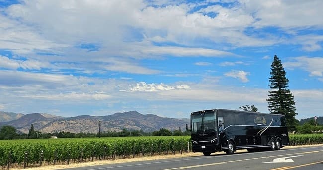 Shuttle driving past Napa Valley vineyards with mountain views