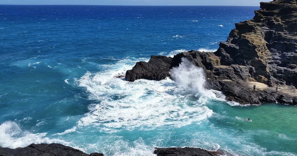 Rugged volcanic coastline with crashing waves on Oahu shore