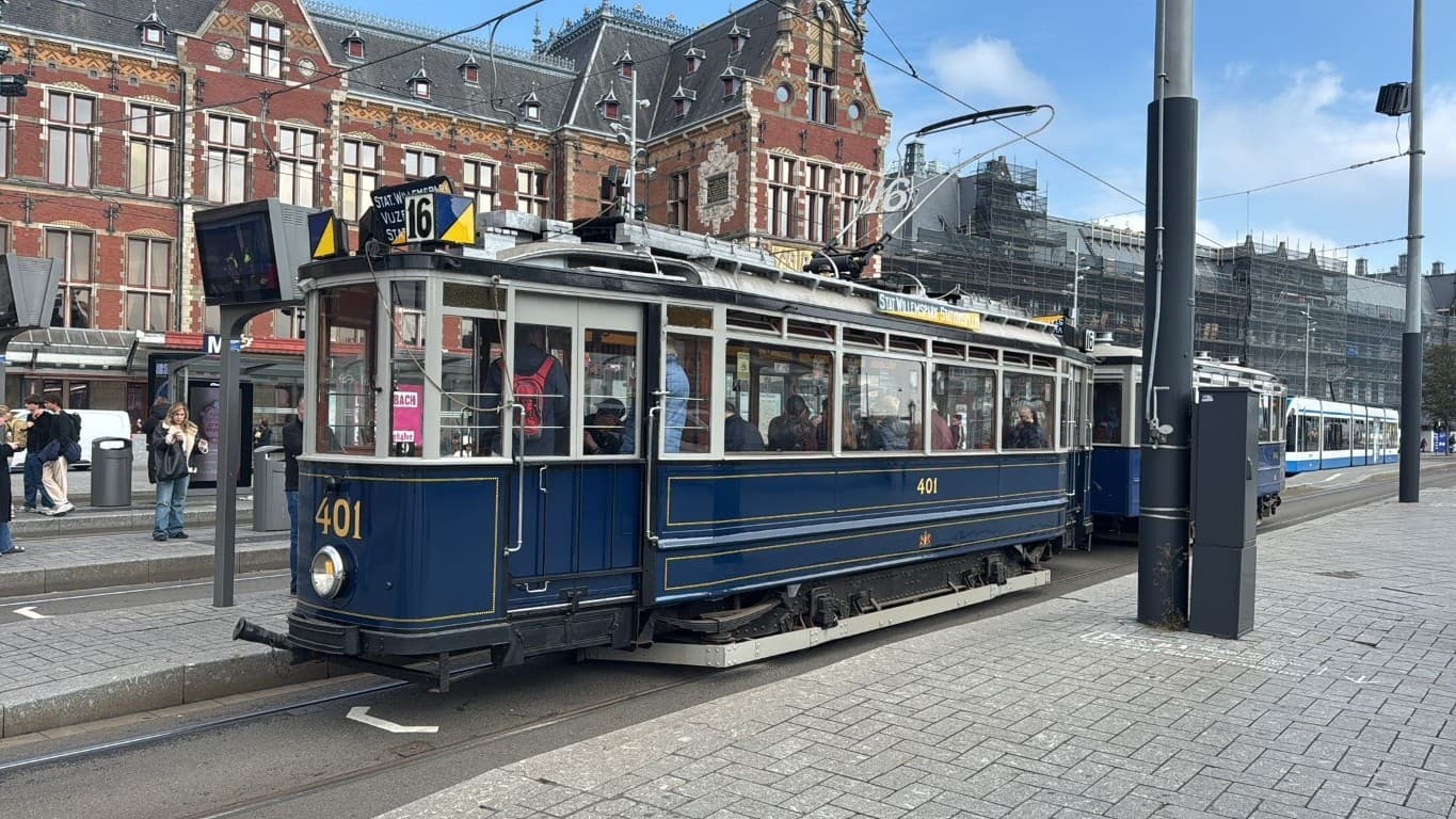 Vintage tram at historic city station platform, urban streetscape
