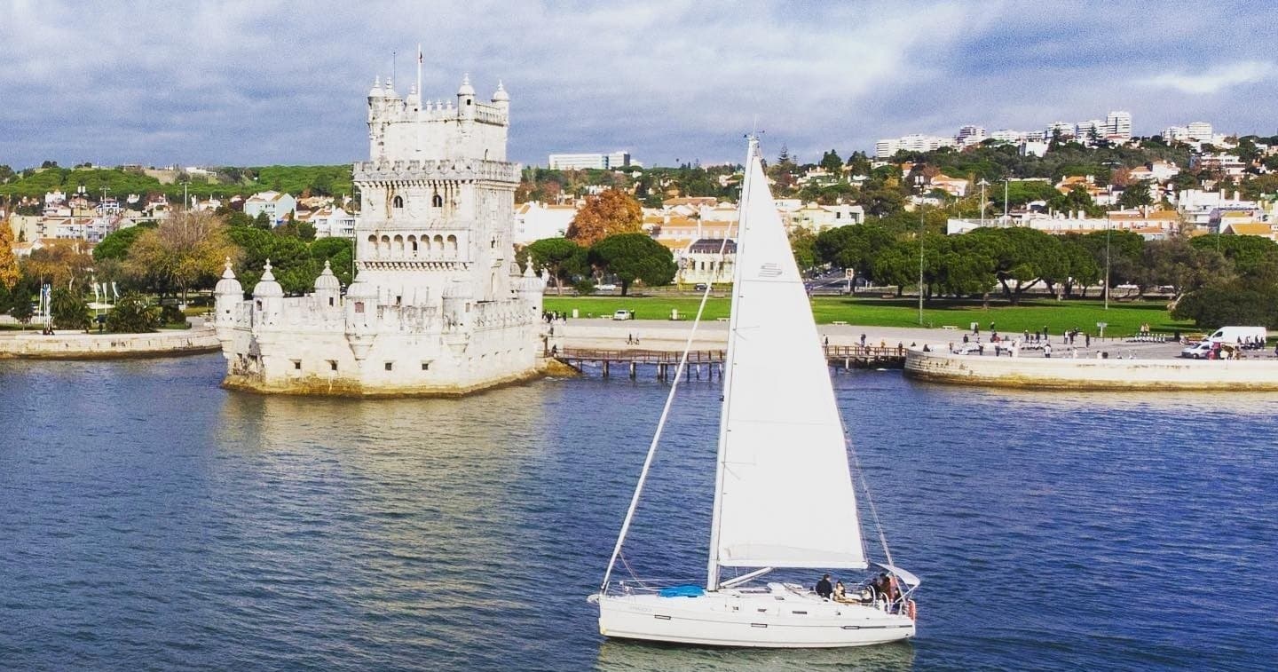 Sailboat cruising past Belem Tower on Lisbon Tagus River tour
